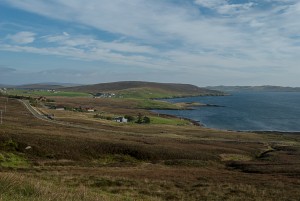 A first view of Shetland, with fjords, rolling green hills and blue sea